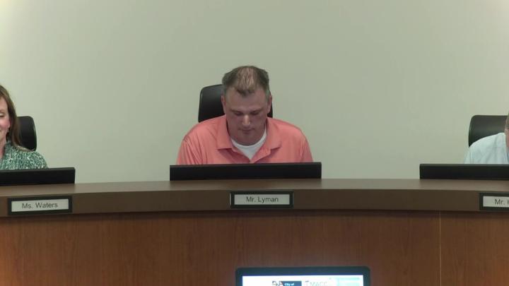 John Lyman sits at the board dais during the March 9, 2026 school board meeting.