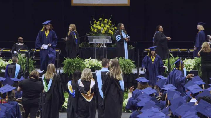 BHS graduation stage, a graduate walks to the stairs.